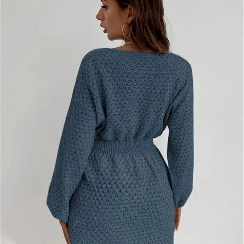 Blue women's knitted dress with hand-crocheted flowers, fitted waist, and round neck.