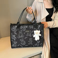 Women's black canvas tote bag with rhombus pattern and sandwich pocket