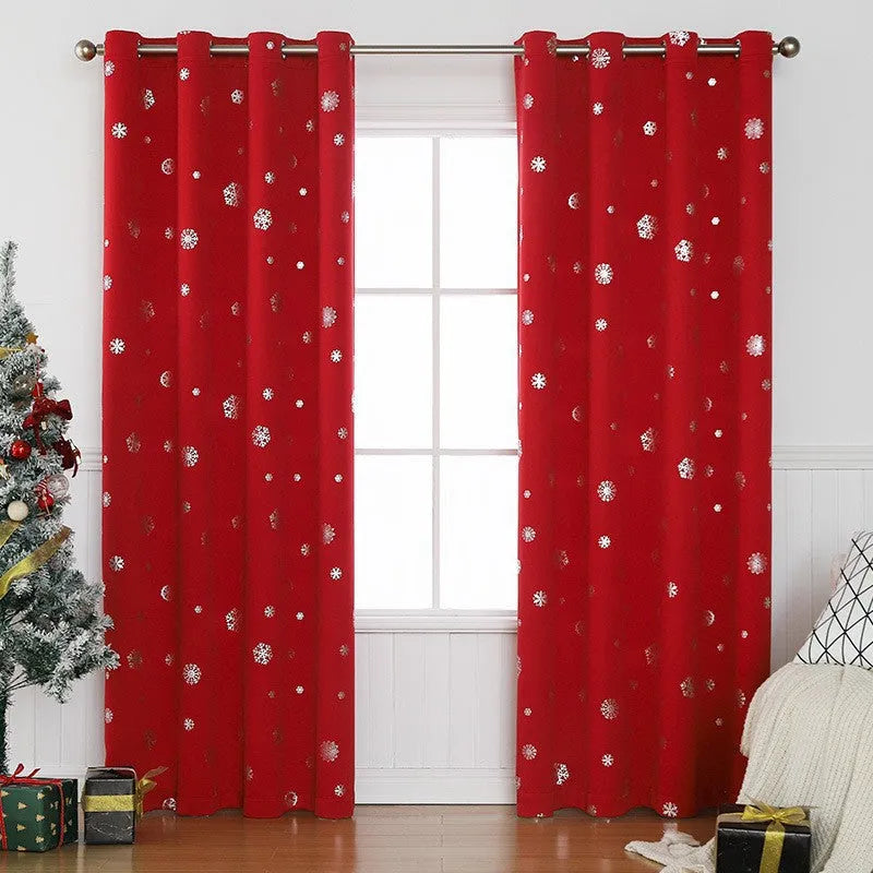 Red snowflake pattern shade cloth curtain with lace loops hanging against window