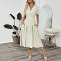 Light green women's shirt dress with lapel collar, waist tie, and side pockets.