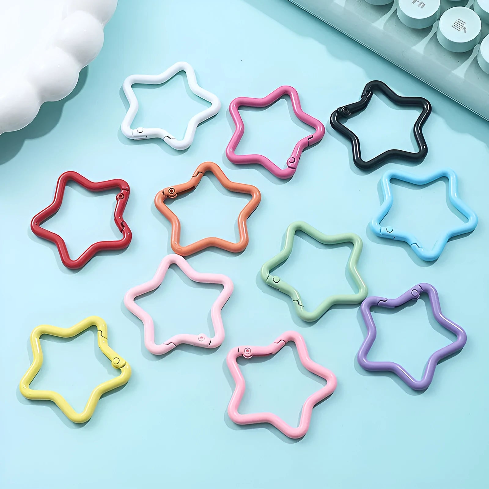 Zinc alloy five-pointed star keychain in macaron colours like light pink and green.