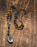 Men's geometric stone cross pendant on a silver ball bead chain with safety lock clasp