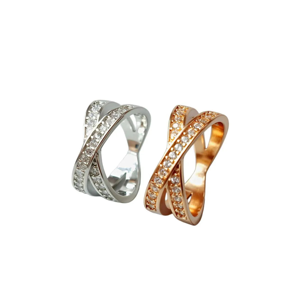 Silver and rose gold metal cross ring with micro-inlaid zircon, showing geometric and heart-shaped design.