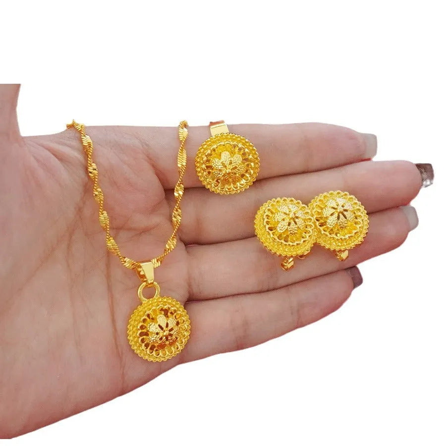 Gold electroplated floral design three-piece jewellery set showing necklace, earrings, and ring on water wave chain.