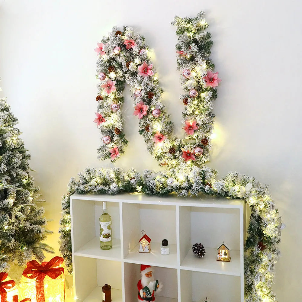 A long, flocked golden rattan Christmas garland draped in a swag on a mantelpiece.