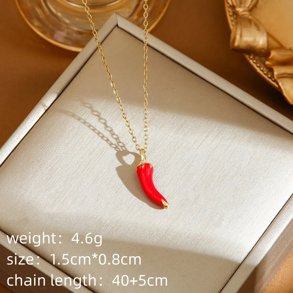 Delicate titanium steel necklace with strawberry, cherry, or pepper charm on an O-ring chain in golden or zircon finishes.