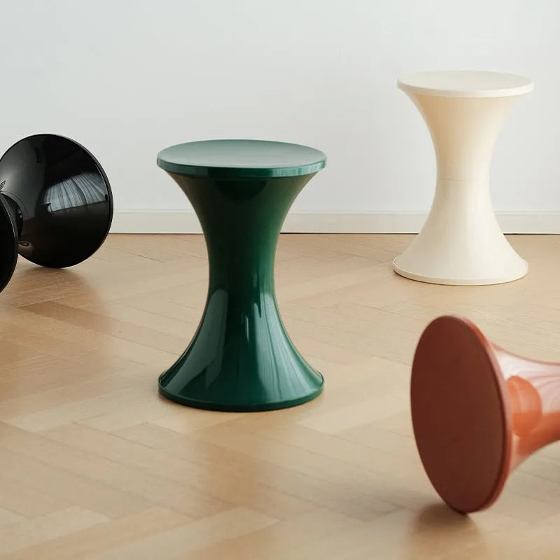 Plastic hourglass shoe changing stool in selected colour on flat surface