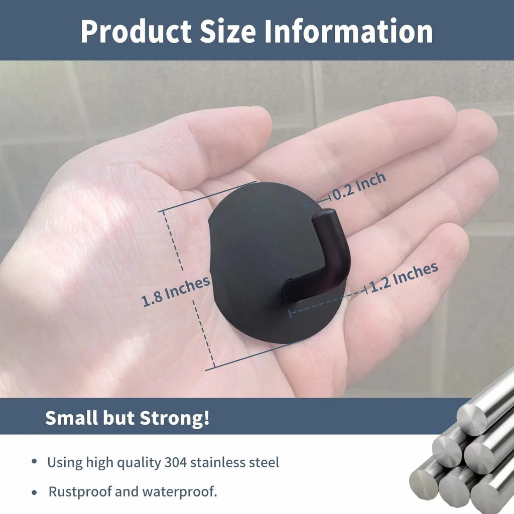 Pair of round stainless steel self-adhesive hooks, one black sanded and one polished, for bathroom or kitchen wall mounting.