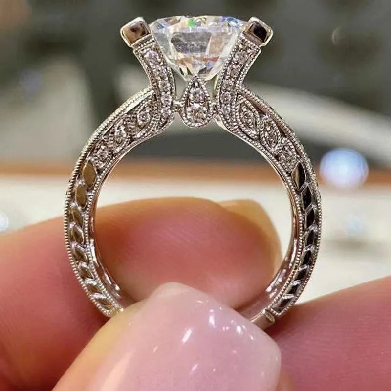 Women's geometric alloy ring with electroplated gold or white finish showing round design elements and available in sizes 5-13