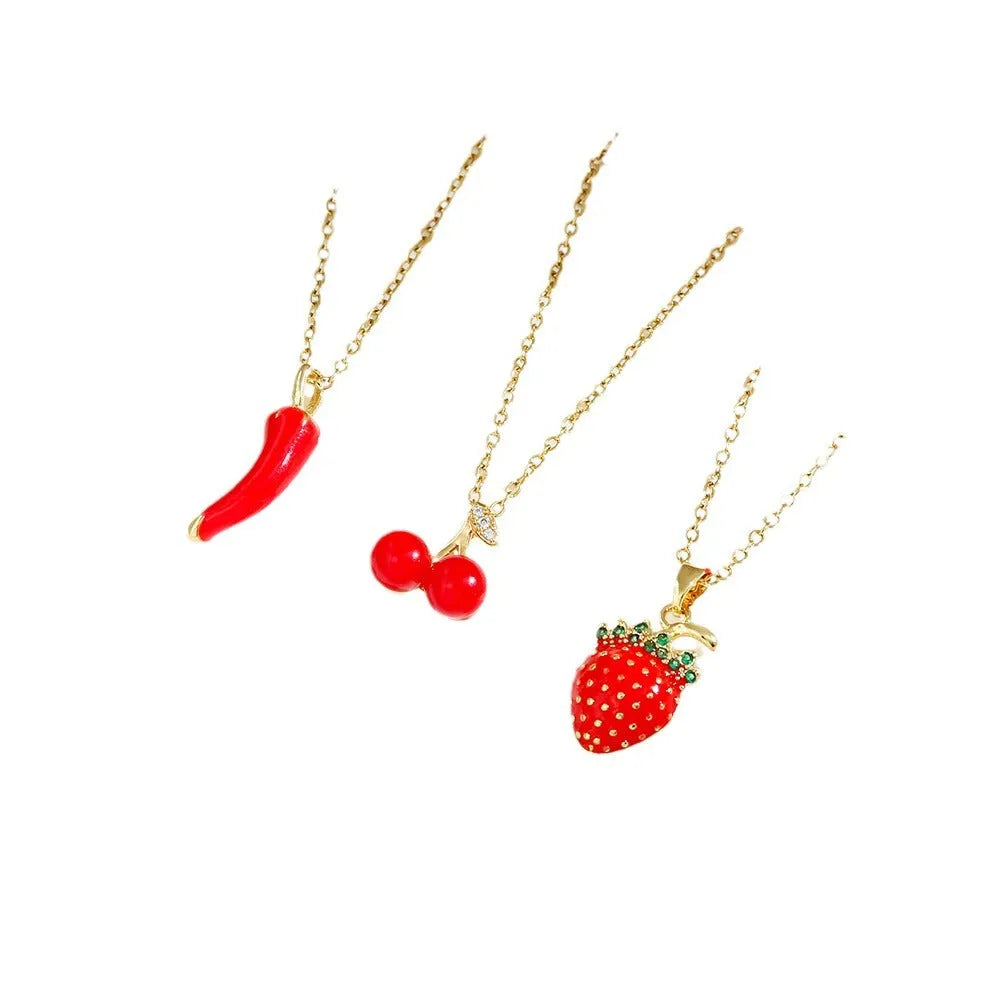 Delicate titanium steel necklace with strawberry, cherry, or pepper charm on an O-ring chain in golden or zircon finishes.