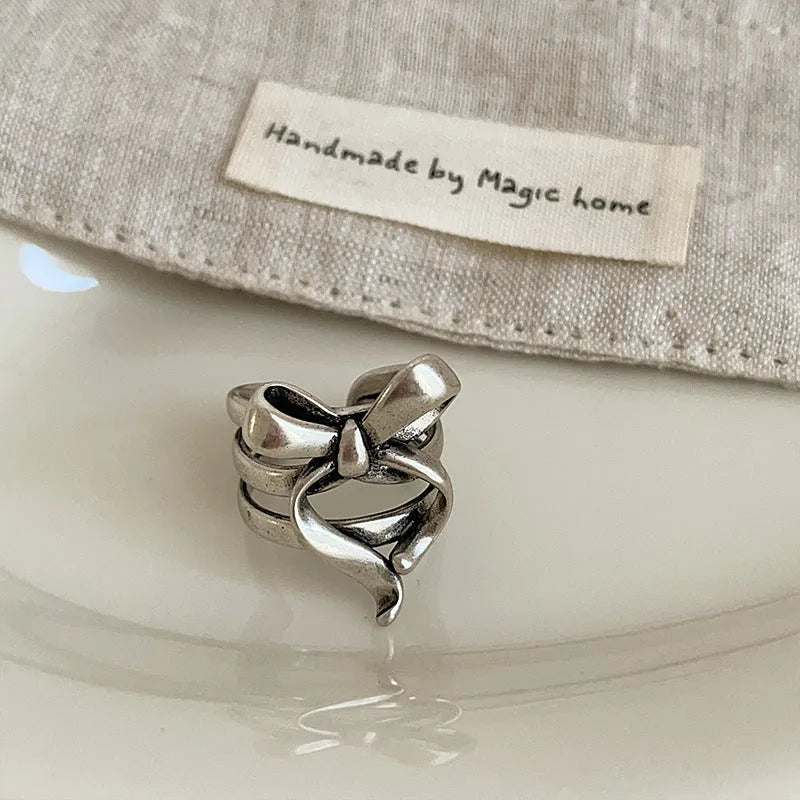 Gold plated wide open ring with retro distressed bow front and geometric metal shape for women