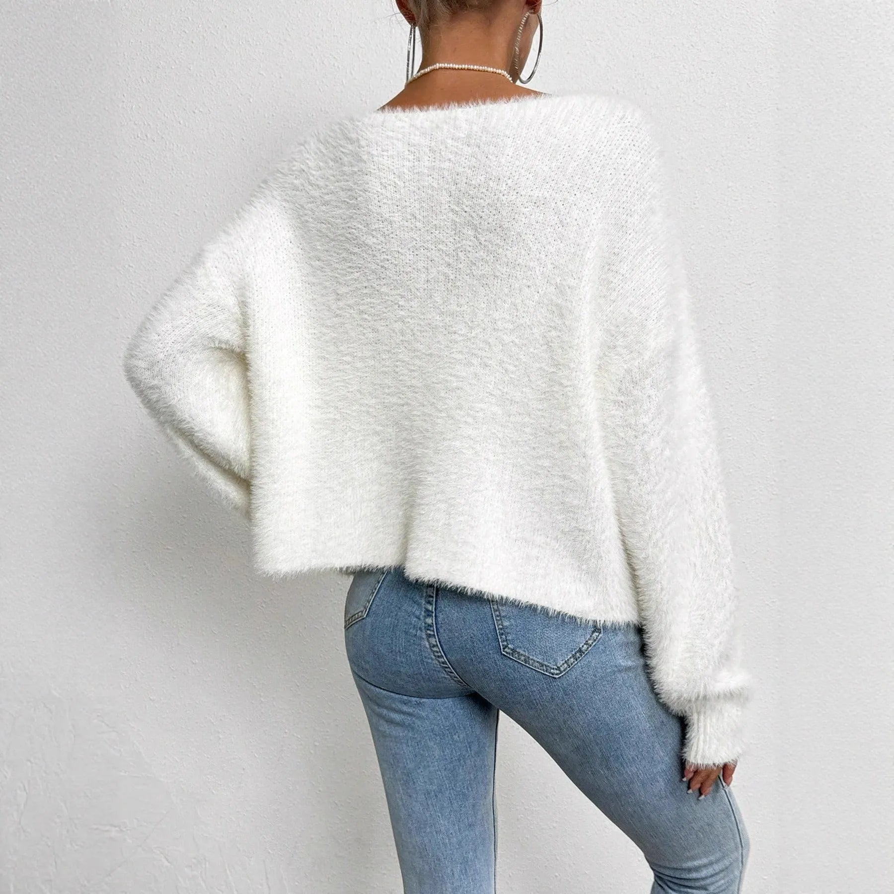White women's V-neck cardigan with bead knit detail on medium thickness polyester fabric