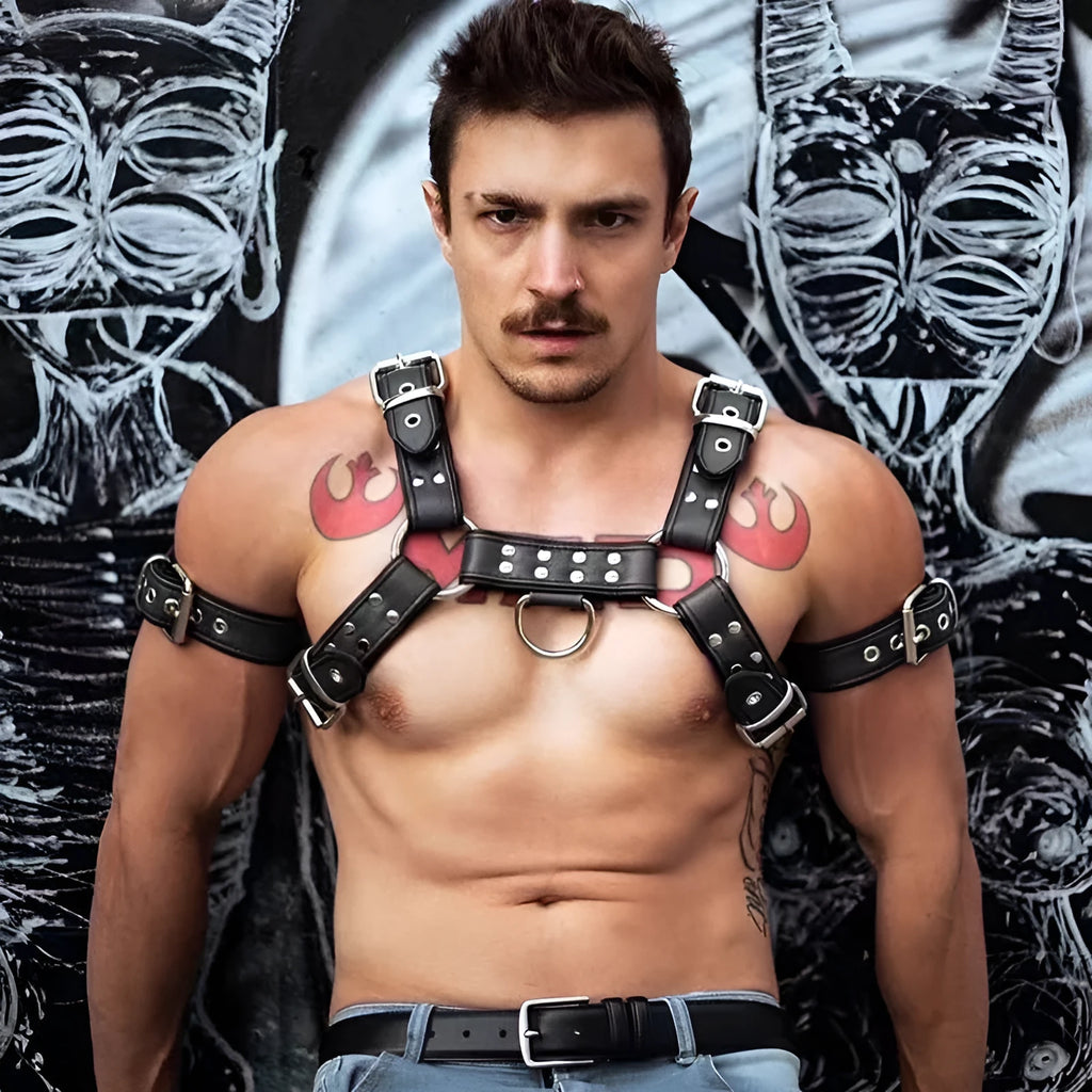 Black leather chest bondage strap with metal buckles on male torso