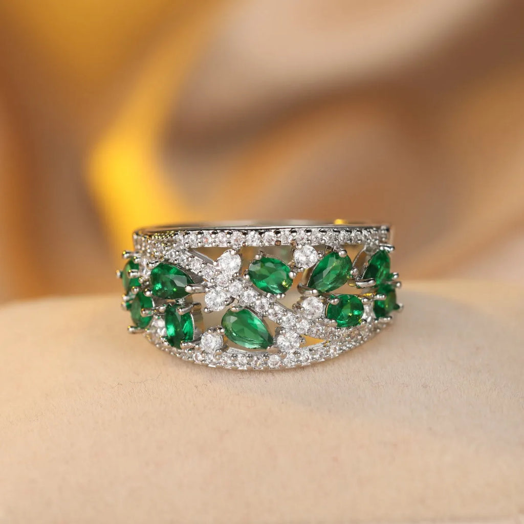 Women's hollow round fashion ring in gold or platinum finish with sapphire blue or white diamond accents