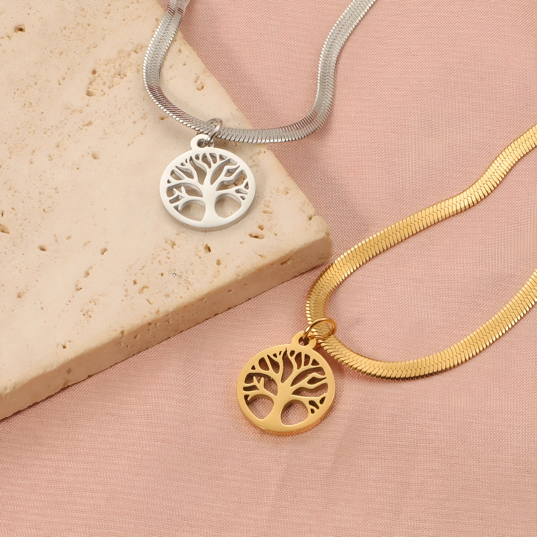 Stainless steel lucky tree pendant necklace on snake bones chain with U-shaped clasp, shown in gold and steel colour options.