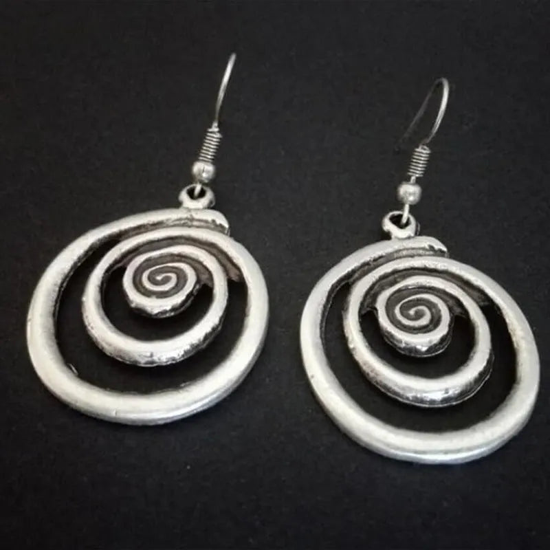 Silver geometric spiral earrings with distressed finish, measuring 2.6 by 5 centimetres