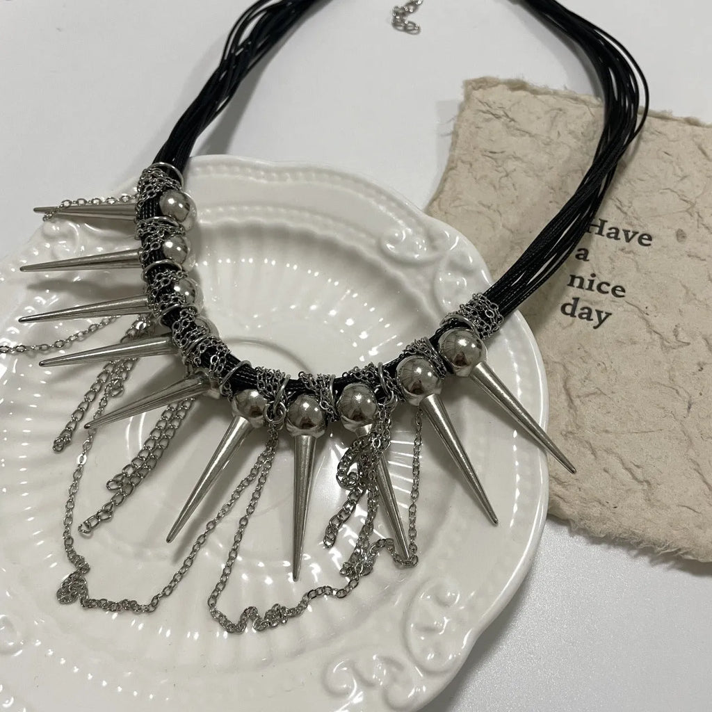 Women's leather tassel necklace with round beads and rivet detailing in electroplated finish
