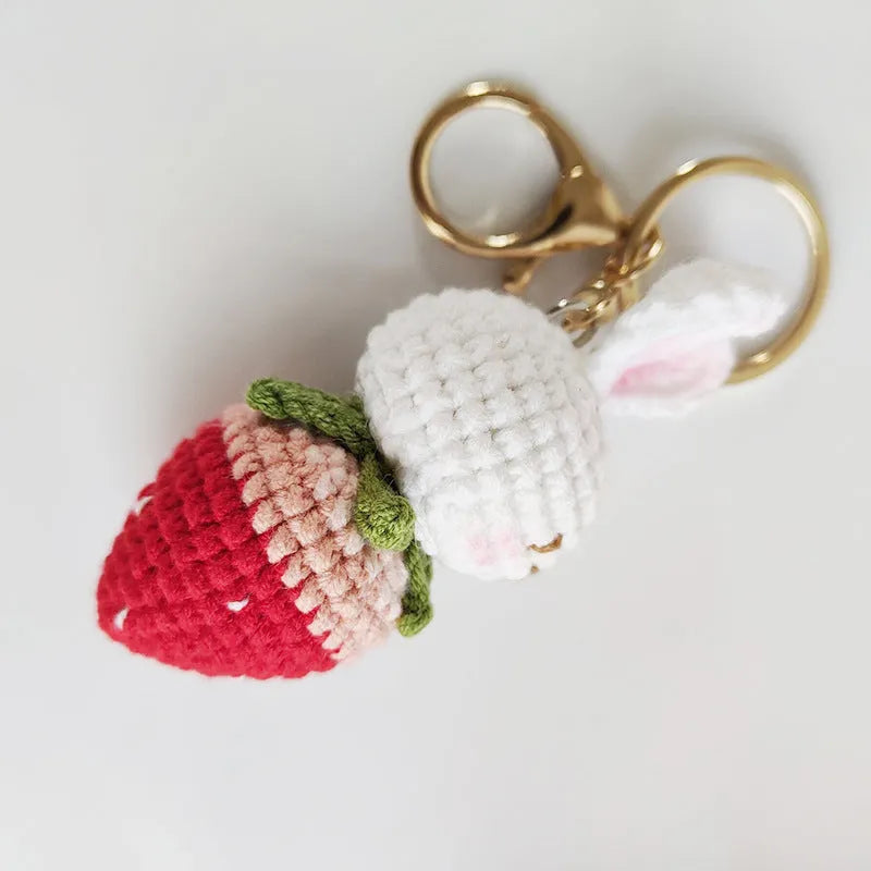 White hand-woven rabbit strawberry pendant charm with key attachment on four-strand doll wire