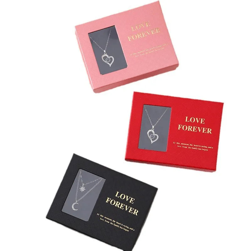 Red Korean style gift box open to show six pink soap flowers, with a matching handbag, for Valentine's Day.