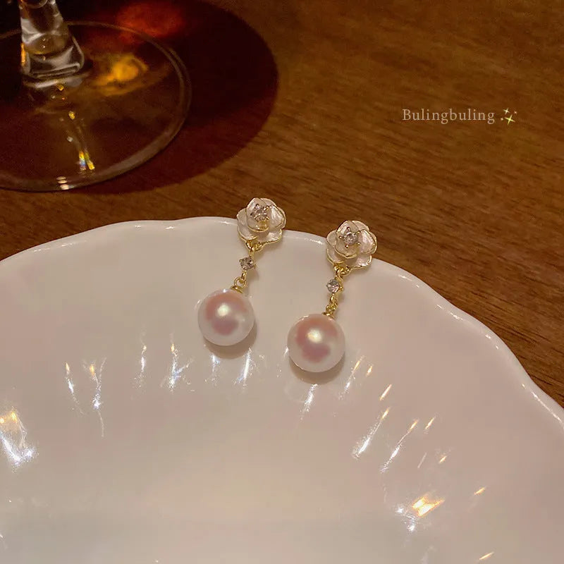 Camellia flower-shaped alloy stud earrings for women with floral design