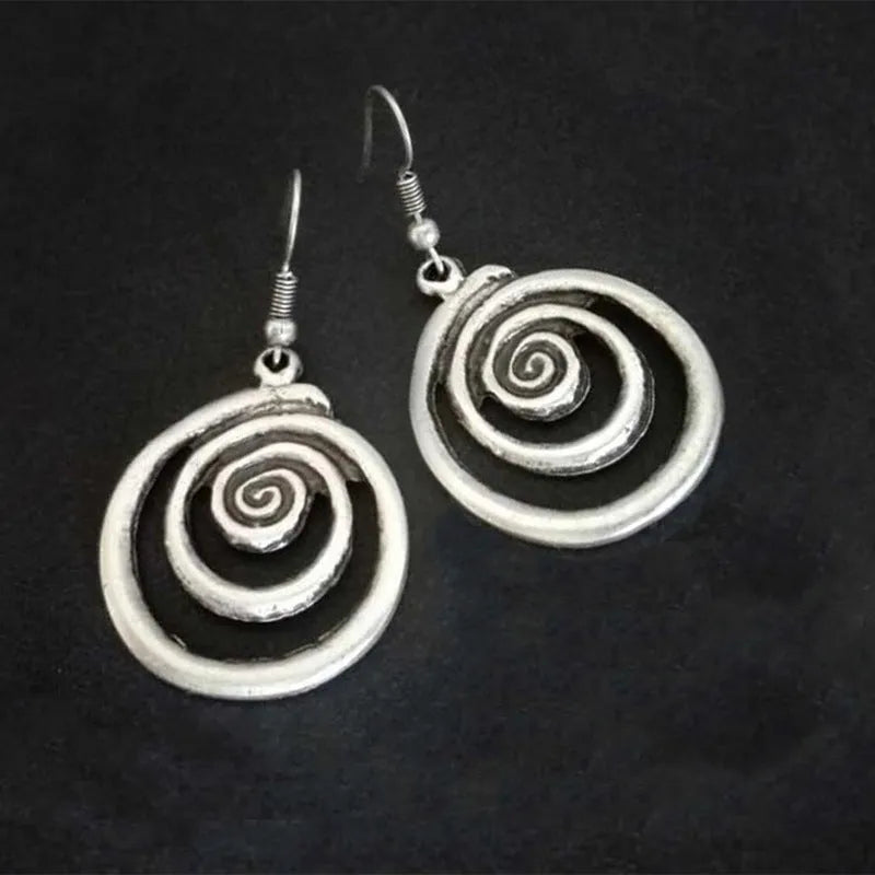Silver geometric spiral earrings with distressed finish, measuring 2.6 by 5 centimetres