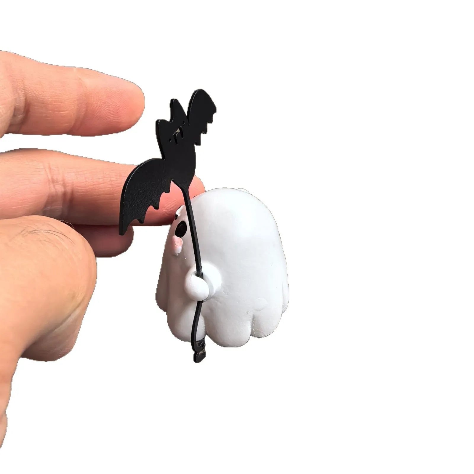 Miniature resin ghost figurine holding a bat, a compact Halloween decoration ornament.