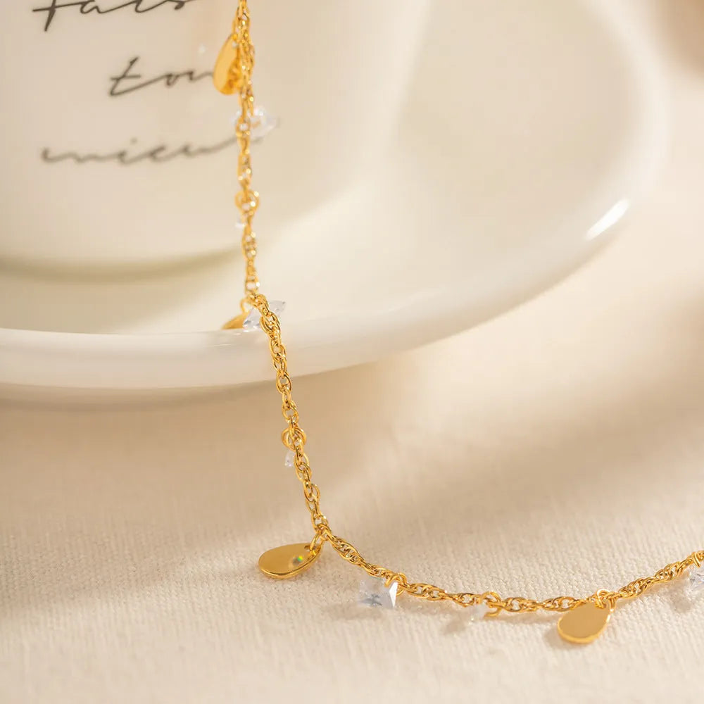 Women's stainless steel anklet with water drop charm and geometric tassel design