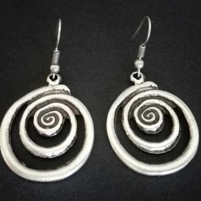 Silver geometric spiral earrings with distressed finish, measuring 2.6 by 5 centimetres