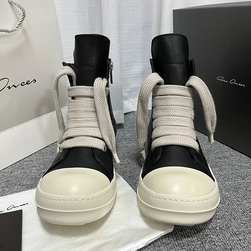 Black high-top leather sneakers with side zipper and round toe on a white background