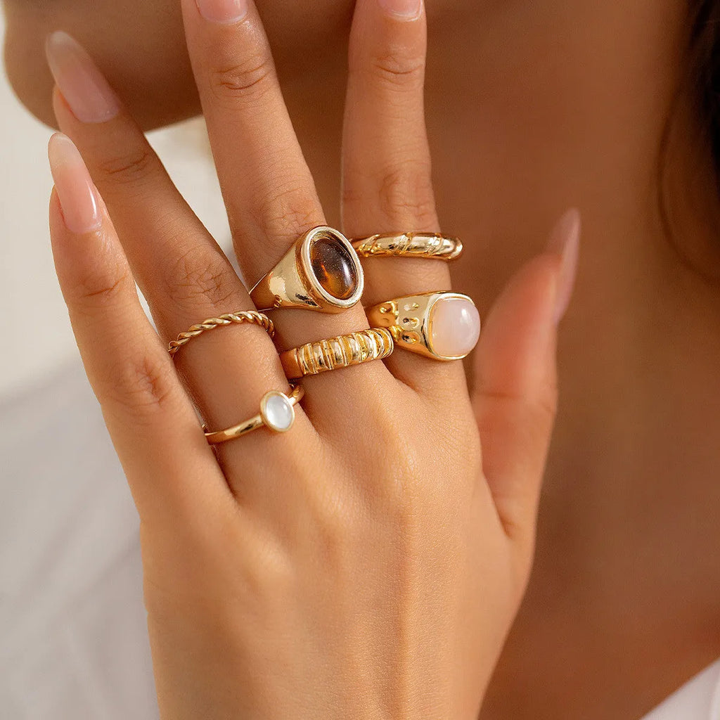 Light gold electroplated alloy ring set with six geometric and round designs for women