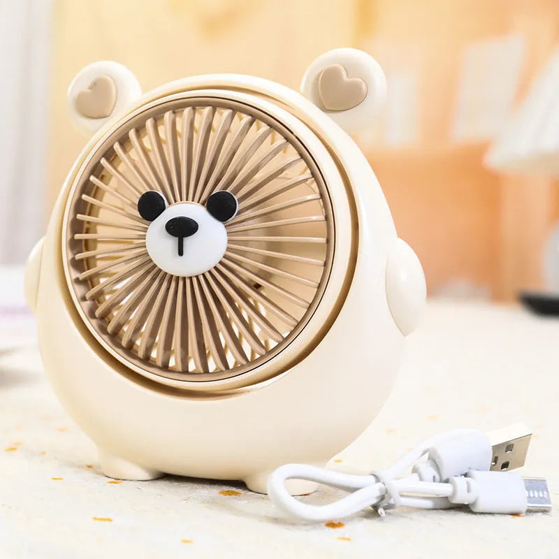 Cute dog design USB desktop electric fan in bear apricot colour on a wooden desk.