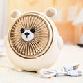 Cute dog design USB desktop electric fan in bear apricot colour on a wooden desk.