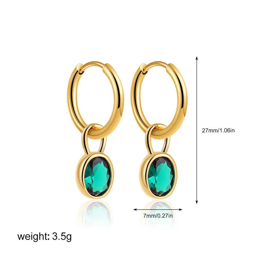 Close-up of a women's retro-style oval zircon drop earring in copper setting.