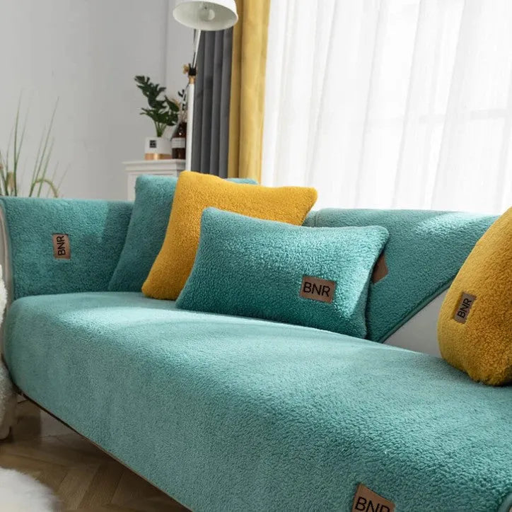 Lambswool sofa slipcover in a solid colour draped over a sofa, showing its simple cloth liner style.