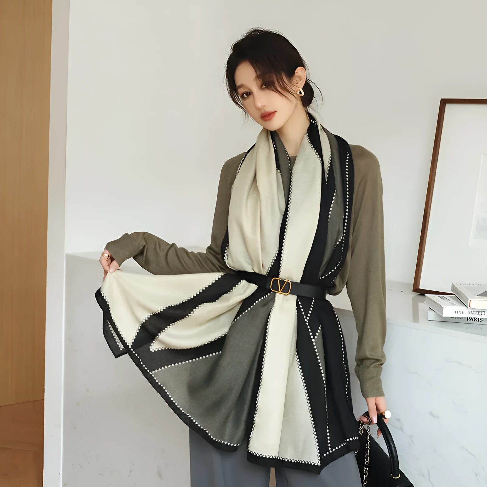 A woman wearing a long polyester scarf with fringe trim, shown in one of three available colour styles.