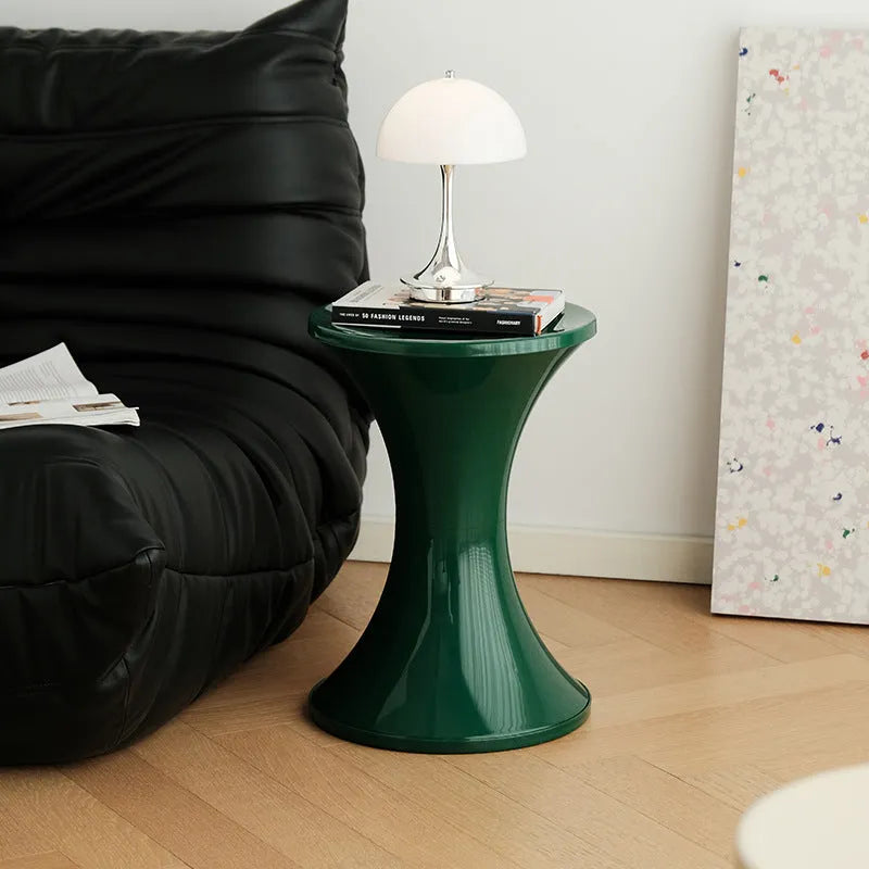 Plastic hourglass shoe changing stool in selected colour on flat surface
