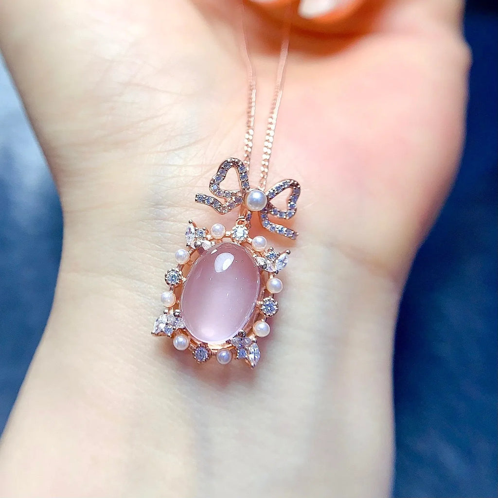 Geometric pendant necklace with pink rose quartz crystal in rose gold plated 925 silver setting.