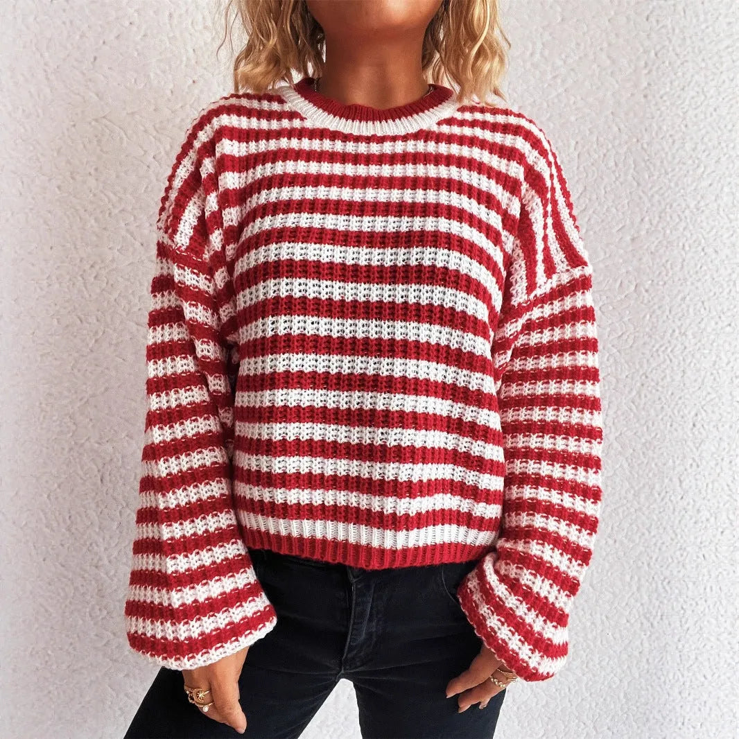 Women's loose black and white striped pullover sweater with a round neck and long sleeves.