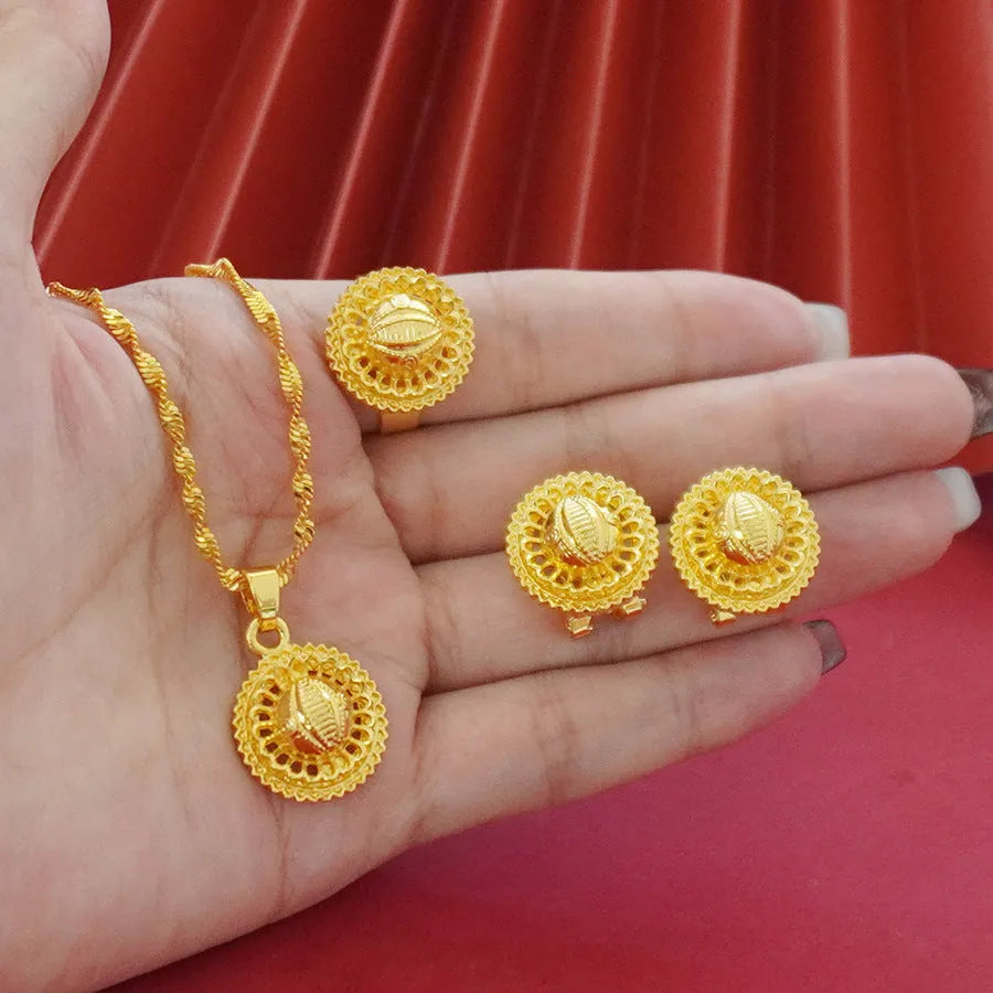Gold electroplated floral design three-piece jewellery set showing necklace, earrings, and ring on water wave chain.