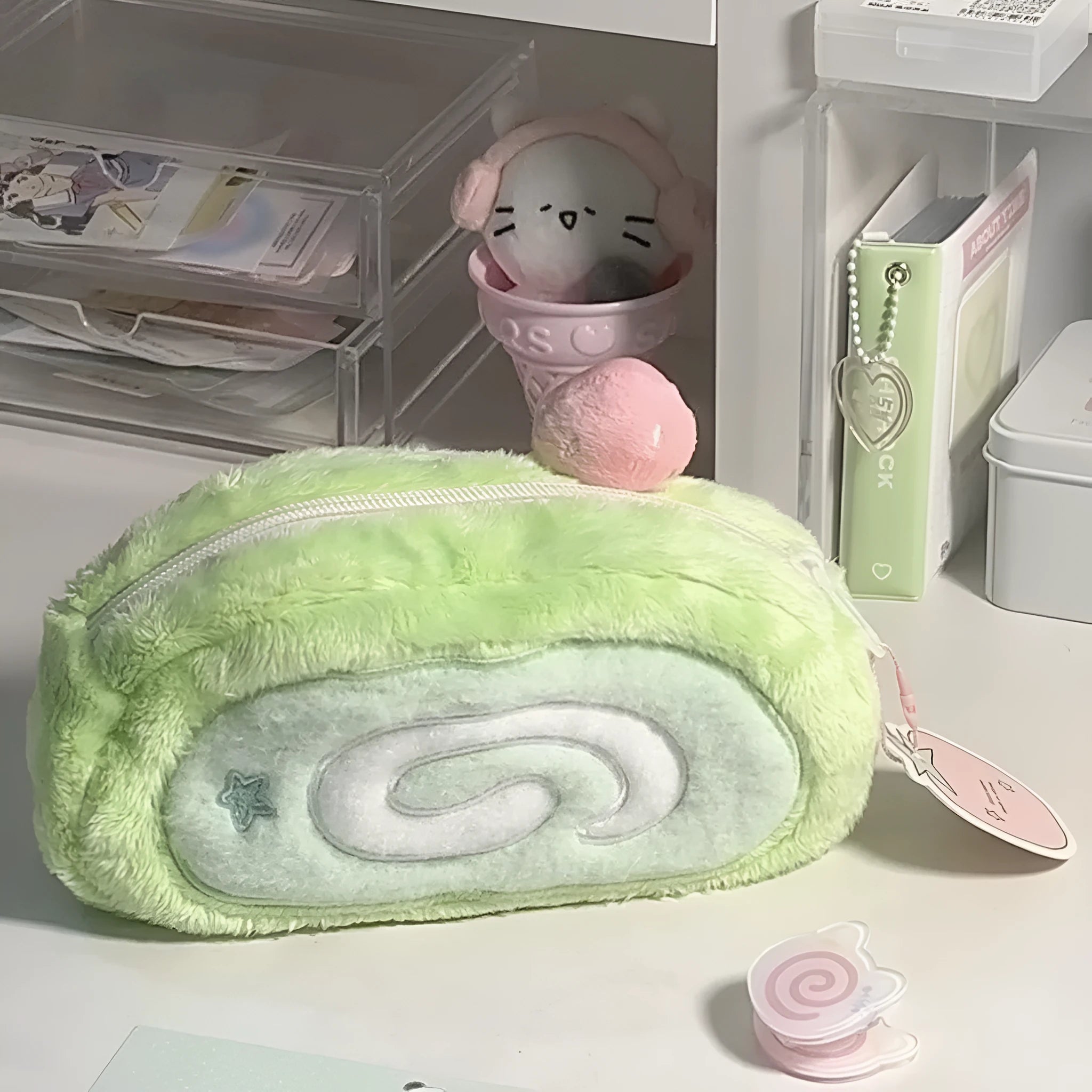 Swiss roll cake design pencil case in plush velvet with a zip closure.