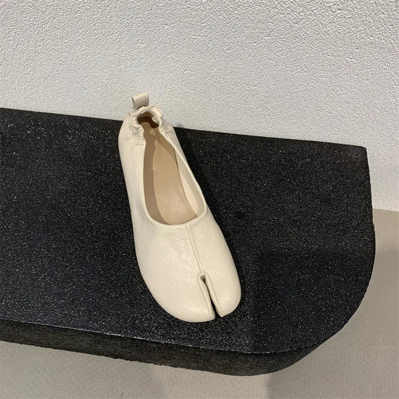 Women's apricot chunky heel pumps with a round toe and distinctive split toe horseshoe design.