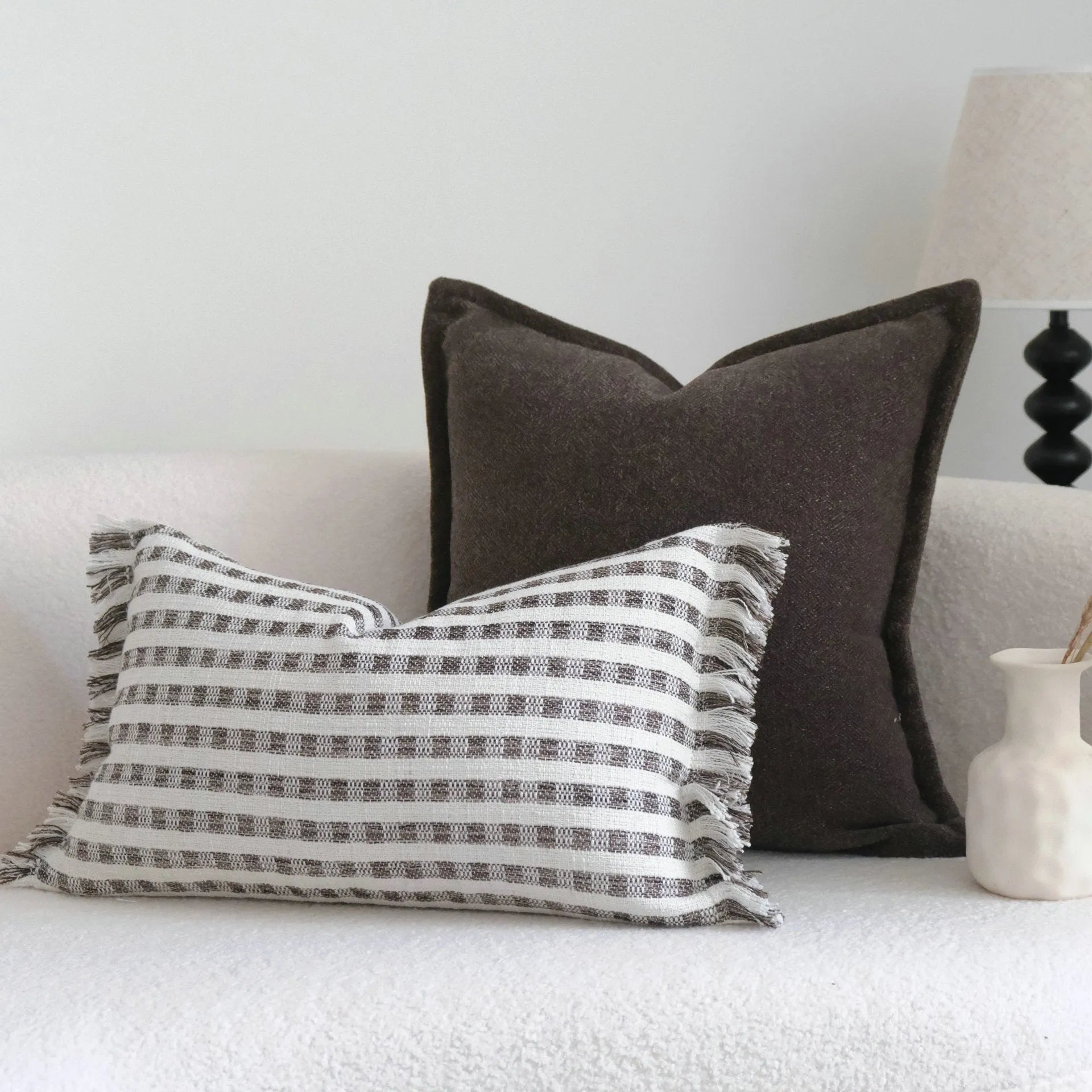 Coffee brown striped mid-century modern cushion with Chinese classical design on sofa