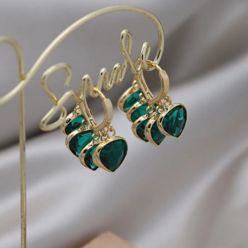 Korean style green glass heart-shaped ear clip earrings with alloy and artificial gemstone inlay.