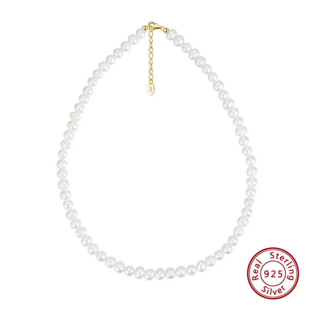 Women's simple sterling silver necklace with round freshwater pearls on an adjustable chain.