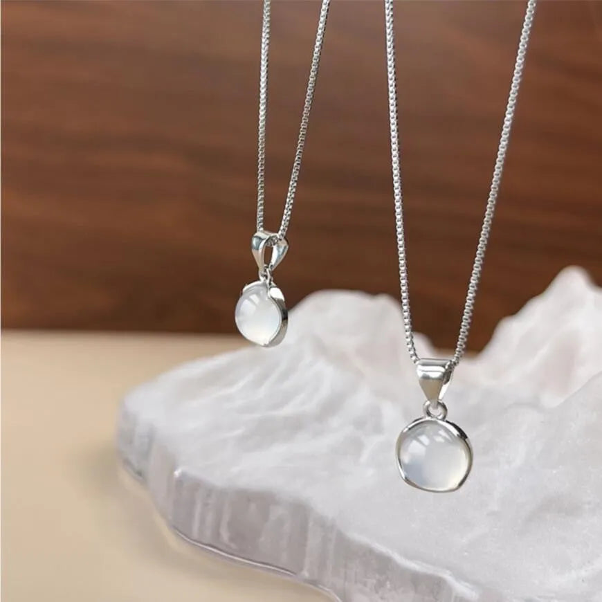 Oval artificial crystal pendant necklace with eight-point star design on adjustable box chain