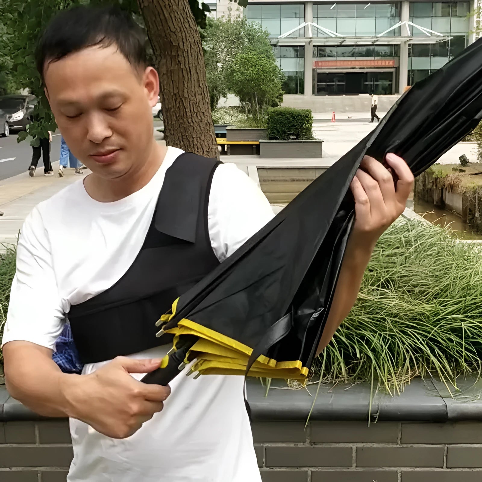 Black portable umbrella holder with shoulder strap for hands-free use with a 10-bone manual umbrella.