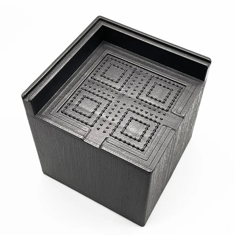 Four black plastic furniture risers or feet for beds and sofas