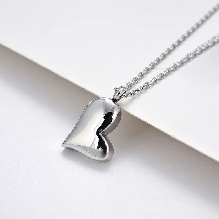 Silver curved peach heart pendant necklace on stainless steel chain with love pattern