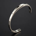 Open-ended stainless steel bracelet for women with inlaid zircon stones in rose, gold, or steel colour.