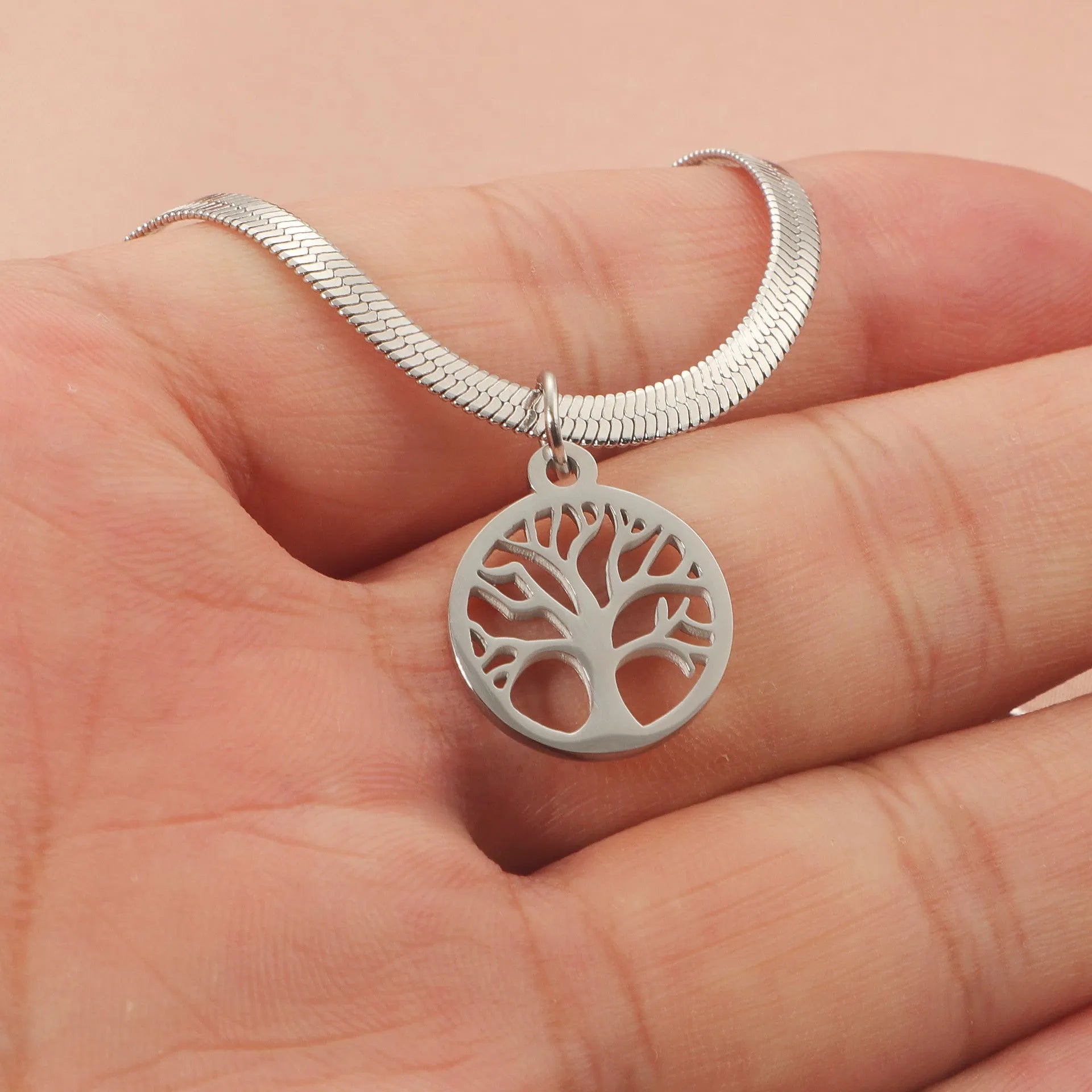 Stainless steel lucky tree pendant necklace on snake bones chain with U-shaped clasp, shown in gold and steel colour options.